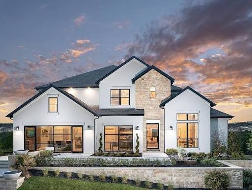 Two-story white home at sunset in Hidden Creeks at Lakewood Park, Cedar Park, Texas
